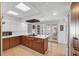 Spacious kitchen with center island, stainless appliances, wood cabinetry, and sliding doors to the patio at 448 58Th St, Sarasota, FL 34243