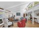 Open living room with vaulted ceilings, hardwood floors, modern furnishings, and lots of natural light at 448 58Th St, Sarasota, FL 34243