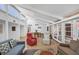 Bright living room with hardwood floors, vaulted ceilings, modern decor, and access to the pool area at 448 58Th St, Sarasota, FL 34243