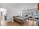 Main bedroom with view to outdoor patio and pool area, featuring a neutral color palette at 448 58Th St, Sarasota, FL 34243