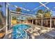 This screened pool and patio area features brick pavers, chaise lounges, and backyard access at 448 58Th St, Sarasota, FL 34243