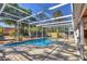 A screened pool and brick paver patio area is surrounded by lush greenery for privacy at 448 58Th St, Sarasota, FL 34243