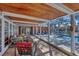 A covered pool area with stylish seating, brick pavers, and access to the pool and jacuzzi at 448 58Th St, Sarasota, FL 34243