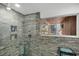 Shower with stylish gray brick tiling and a view to the outside at 448 58Th St, Sarasota, FL 34243