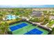 Aerial showcases tennis courts, pools, and clubhouse in a planned community with a variety of recreational opportunities at 5416 Hope Sound Cir, Sarasota, FL 34238