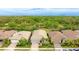 Aerial view of home showcasing landscaping, a brick driveway, and a view of the surrounding greenery at 5416 Hope Sound Cir, Sarasota, FL 34238