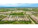 Panoramic aerial view of a neighborhood featuring well-maintained homes, lush greenery, and scenic ponds at 5416 Hope Sound Cir, Sarasota, FL 34238