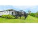 The well-maintained backyard features a screened lanai, a fenced yard, and plenty of green space for outdoor activities at 5416 Hope Sound Cir, Sarasota, FL 34238