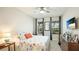 Bedroom boasts a ceiling fan, wall-mounted TV, and a view of the outdoors at 5416 Hope Sound Cir, Sarasota, FL 34238