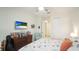Bedroom boasts a ceiling fan, wall-mounted TV, and closet storage at 5416 Hope Sound Cir, Sarasota, FL 34238