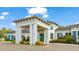 Modern clubhouse exterior with a grand entrance, manicured landscaping, and architectural details at 5416 Hope Sound Cir, Sarasota, FL 34238