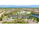 Overhead view of a luxury community clubhouse, pool, tennis courts, and well-manicured landscaping at 5416 Hope Sound Cir, Sarasota, FL 34238