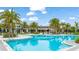 Stunning community pool surrounded by palm trees, featuring spacious deck and plenty of seating at 5416 Hope Sound Cir, Sarasota, FL 34238