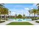 Resort-style community pool surrounded by palm trees, lounge chairs, and well-maintained grounds at 5416 Hope Sound Cir, Sarasota, FL 34238