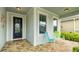 Inviting front porch with seating, decorative touches, and a welcoming ambiance for relaxing outdoor enjoyment at 5416 Hope Sound Cir, Sarasota, FL 34238