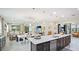 Open-concept kitchen with granite countertops, stainless appliances, an eat-in island bar and seamless flow at 5416 Hope Sound Cir, Sarasota, FL 34238