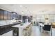 Spacious kitchen features dark cabinets, white marble countertops, large island, and pendant lighting at 5416 Hope Sound Cir, Sarasota, FL 34238