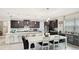 Bright kitchen with dark cabinets, stainless steel appliances, and an eat-in island bar at 5416 Hope Sound Cir, Sarasota, FL 34238