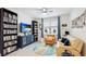Cozy living room with built-in bookcases, a comfortable seating area, and a large window at 5416 Hope Sound Cir, Sarasota, FL 34238