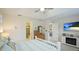 Bright bedroom boasts a ceiling fan, wall-mounted TV, and access to an en-suite bathroom at 5416 Hope Sound Cir, Sarasota, FL 34238