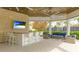 Stylish outdoor bar area with seating, a TV, and a relaxing lounge area with comfortable furniture at 5416 Hope Sound Cir, Sarasota, FL 34238