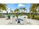 Community area featuring a fire pit with comfortable chairs and lush landscaping by the pool at 5416 Hope Sound Cir, Sarasota, FL 34238