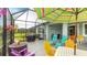 Enjoy outdoor living on this screened lanai with a dining table, seating, and a beautiful view of the fenced backyard at 5416 Hope Sound Cir, Sarasota, FL 34238