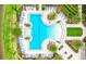 Aerial shot showcases a modern, resort-style swimming pool with ample lounge chairs and lush tropical landscaping at 5416 Hope Sound Cir, Sarasota, FL 34238