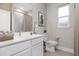 Bright bathroom features a tile surround shower, white cabinetry and a modern countertop at 5454 Rhapsody Ave, North Port, FL 34288