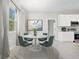 Dining area with modern table and chairs next to the kitchen at 5454 Rhapsody Ave, North Port, FL 34288