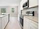 Clean modern kitchen with stainless steel appliances and white cabinets at 5454 Rhapsody Ave, North Port, FL 34288