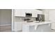 Bright kitchen featuring stainless appliances, white cabinetry, and a breakfast bar at 5454 Rhapsody Ave, North Port, FL 34288