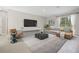 Comfortable living room area features a large tv and modern furnishings at 5454 Rhapsody Ave, North Port, FL 34288