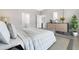 Serene main bedroom with a decorative dresser and an ensuite bathroom at 5454 Rhapsody Ave, North Port, FL 34288