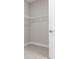 Bright walk-in closet features wire shelving and modern, gray wood look ceramic tile at 5454 Rhapsody Ave, North Port, FL 34288