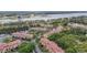 Aerial view of condo community near a lake, highlighting lush landscaping and convenient parking at 5691 Bentgrass Dr # 211, Sarasota, FL 34235