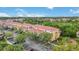 Aerial view of condominium complex with red tile roofs, surrounded by mature trees and landscaping at 5691 Bentgrass Dr # 211, Sarasota, FL 34235