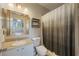 Bathroom featuring vanity with granite countertop, a shelf, and a shower with decorative curtain at 5691 Bentgrass Dr # 211, Sarasota, FL 34235