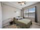 This bedroom features a ceiling fan, window, and unique decor at 5691 Bentgrass Dr # 211, Sarasota, FL 34235