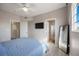 Bedroom features a large window, mirror, and two doors at 5691 Bentgrass Dr # 211, Sarasota, FL 34235