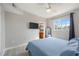 Bedroom featuring hardwood floors, an en-suite bathroom, and large window for plenty of natural light at 5691 Bentgrass Dr # 211, Sarasota, FL 34235