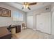 Bright bedroom with wood-look floors and ceiling fan, featuring large closets and a workspace at 5691 Bentgrass Dr # 211, Sarasota, FL 34235