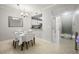 Bright dining area with tile flooring, a view into the kitchen, and staircase access at 5691 Bentgrass Dr # 211, Sarasota, FL 34235
