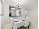 Bright dining room featuring a chandelier and pass-through to the kitchen at 5691 Bentgrass Dr # 211, Sarasota, FL 34235