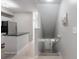 Bright entryway with tile flooring, a staircase to the lower level, and a view of the kitchen at 5691 Bentgrass Dr # 211, Sarasota, FL 34235