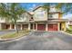 Exterior of townhomes featuring private garage parking, well-maintained landscaping, and neutral color palette at 5691 Bentgrass Dr # 211, Sarasota, FL 34235