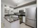 Bright kitchen featuring stainless steel appliances and granite countertops at 5691 Bentgrass Dr # 211, Sarasota, FL 34235