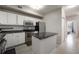 Kitchen with stainless steel appliances, granite countertops, and white cabinetry at 5691 Bentgrass Dr # 211, Sarasota, FL 34235