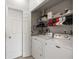 Well-organized laundry room with modern washer and dryer units and ample storage on the shelves at 5691 Bentgrass Dr # 211, Sarasota, FL 34235