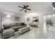 Open-concept living space with a sectional sofa, dining area, and a view into the kitchen at 5691 Bentgrass Dr # 211, Sarasota, FL 34235